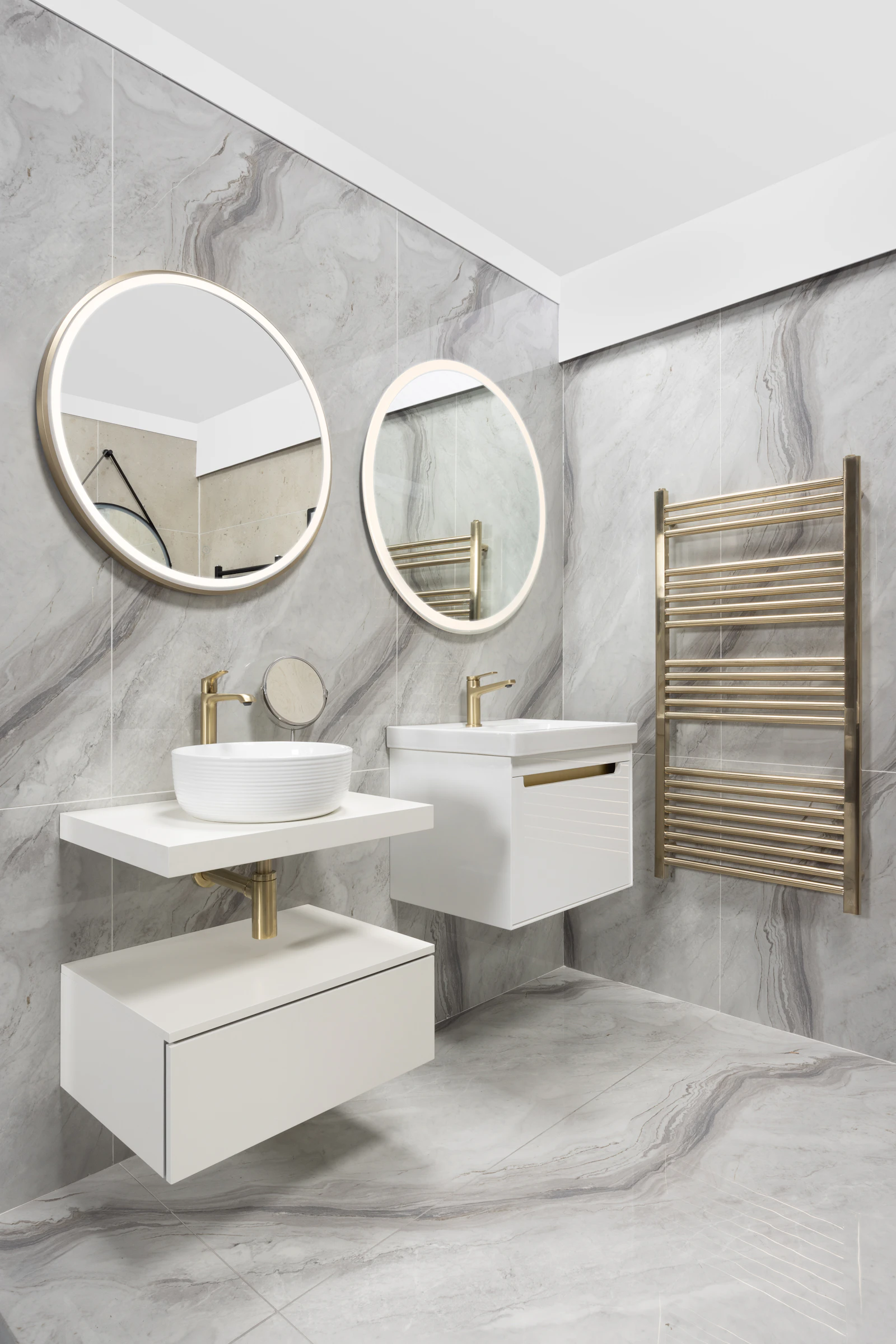 Modern bathroom with gold fixtures and pale marble tile styling