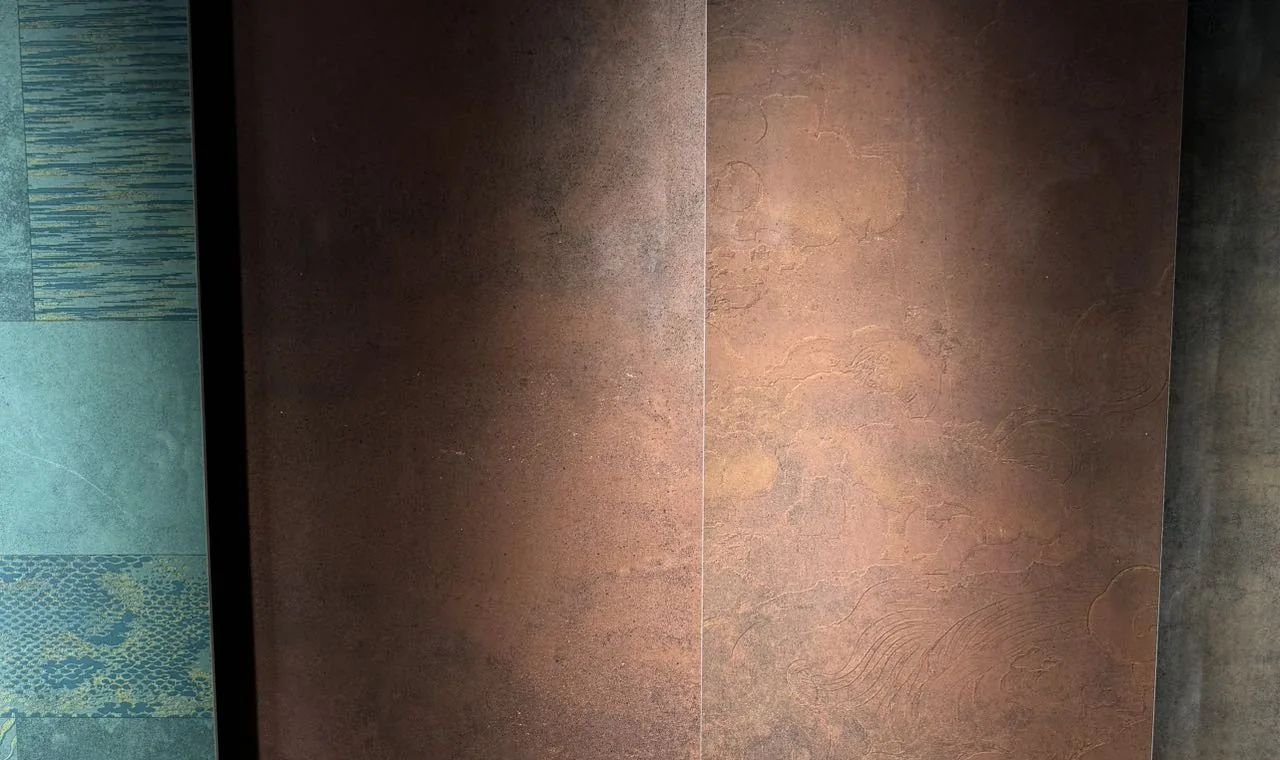 Supplier showroom sample board showing rust-look tile finishes and adjacent decorative samples