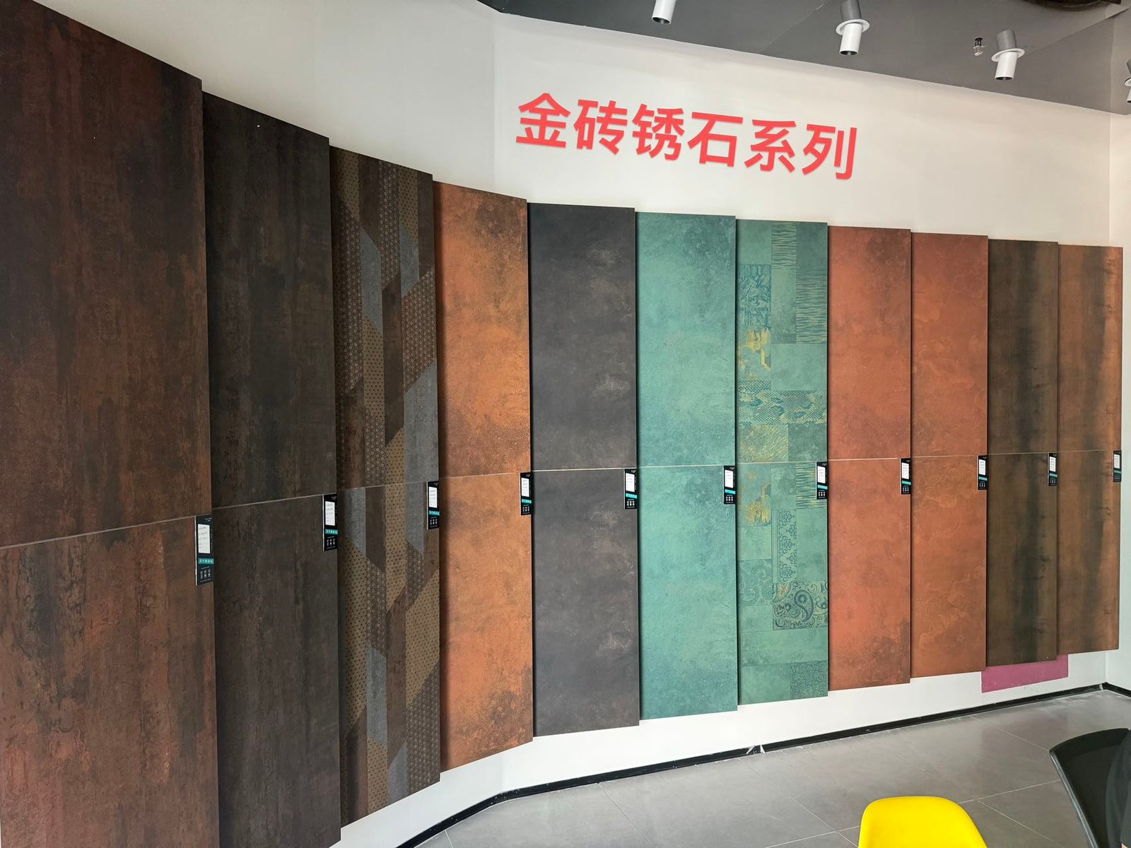 Wide supplier showroom photograph showing the rust-effect tile colour range