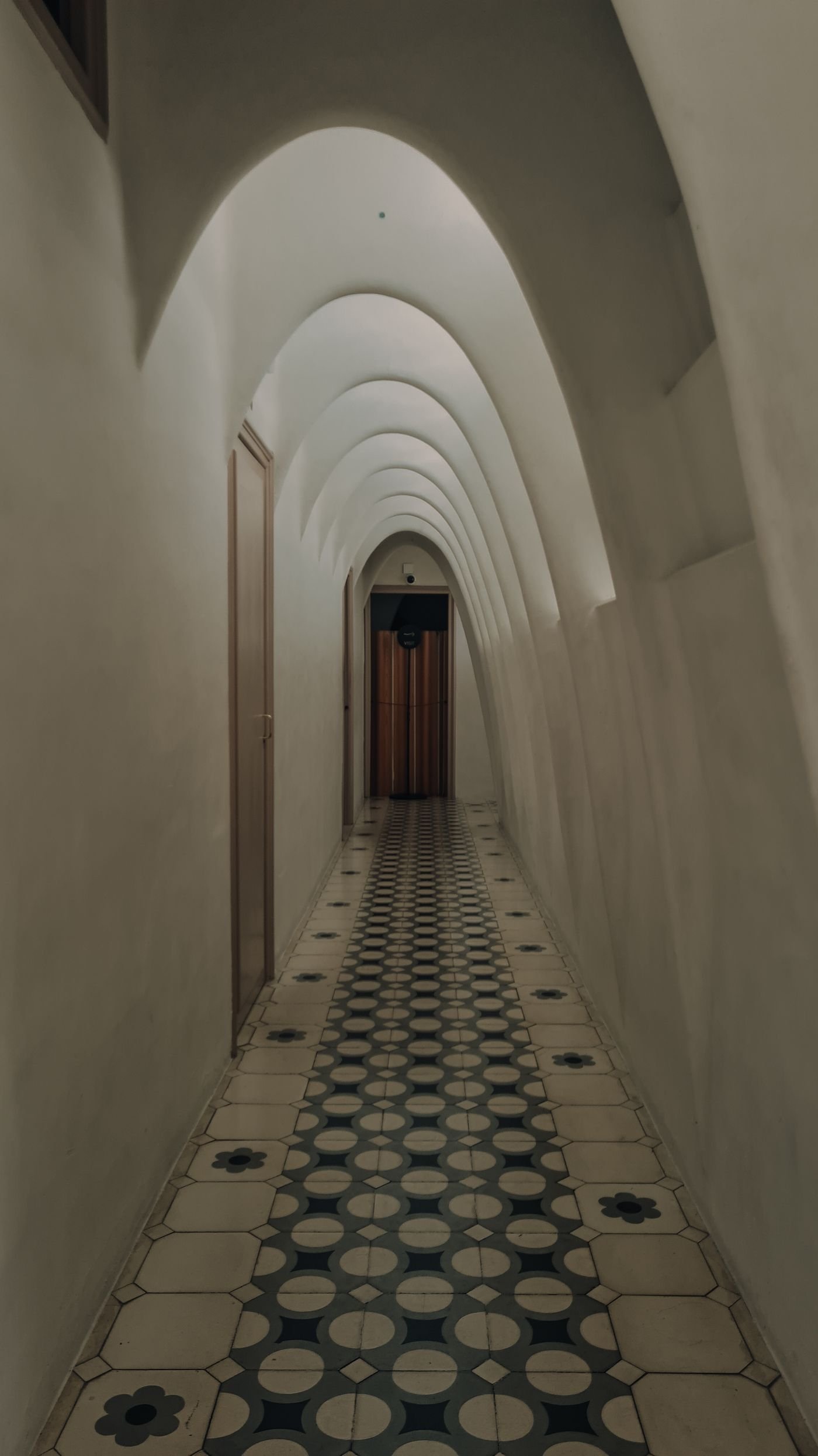 Arched corridor with geometric tiled floor inspiration
