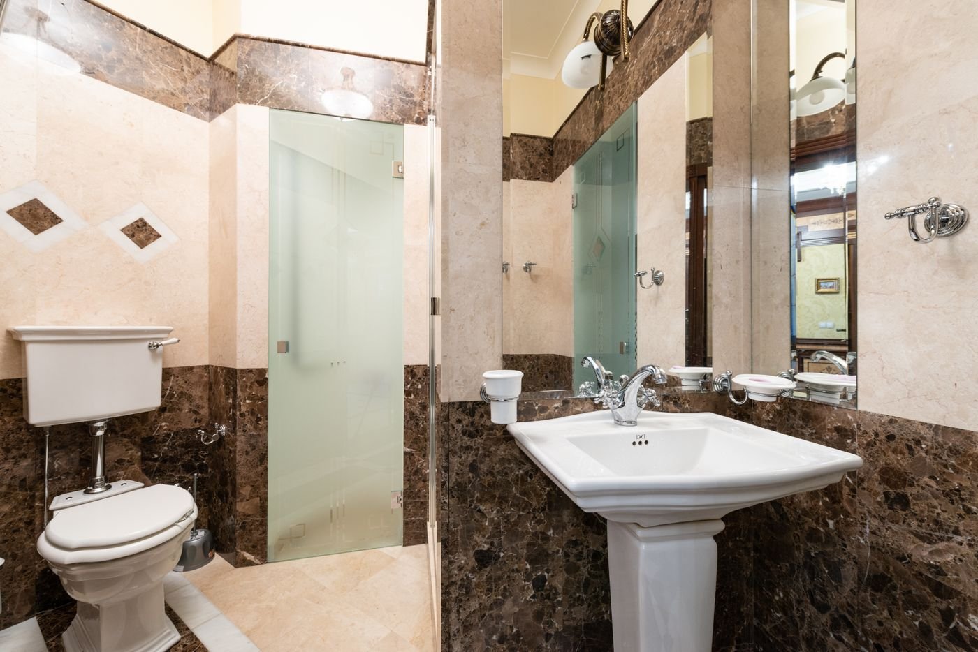 Warm contemporary bathroom finished with brown marble-effect tiles