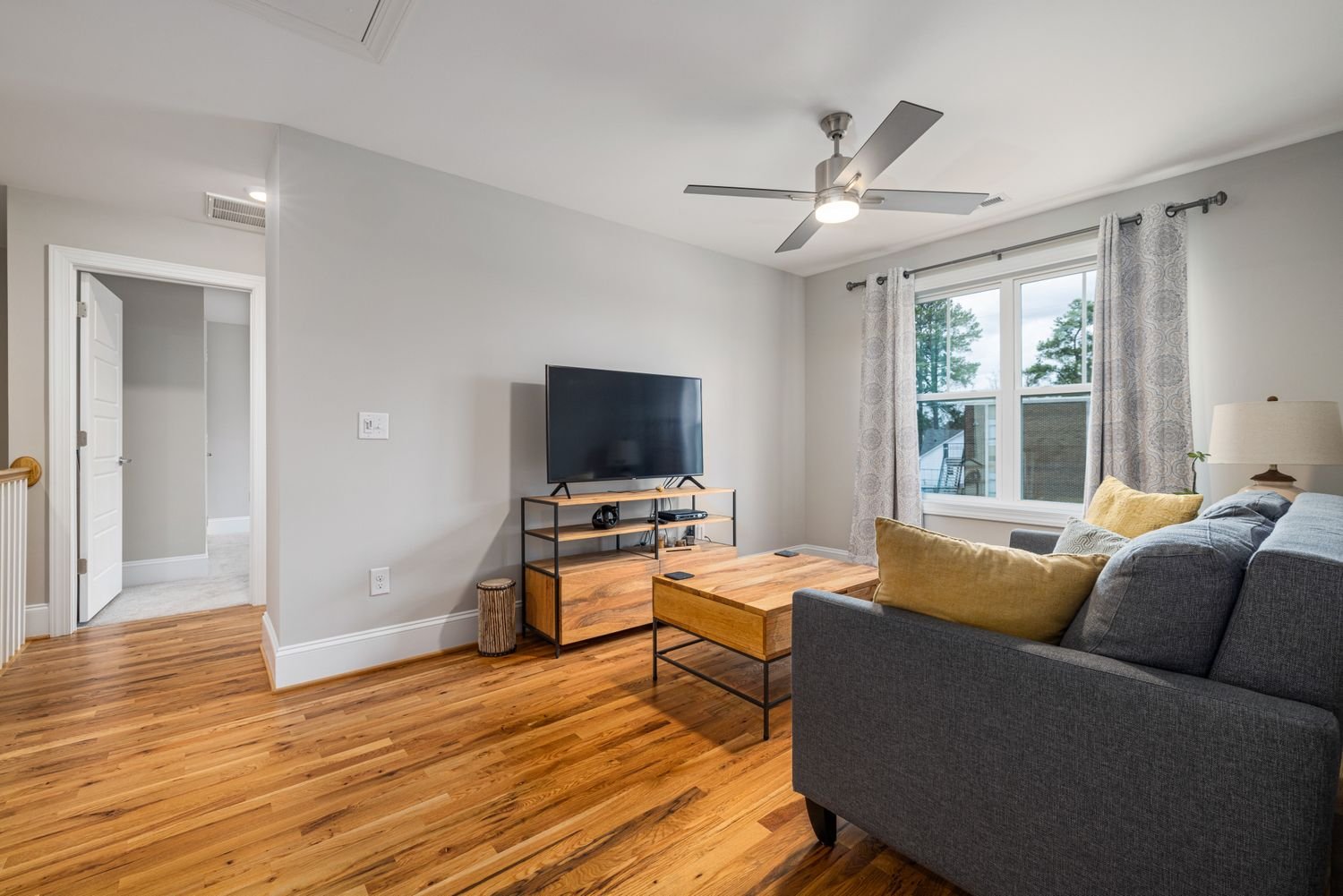 Contemporary living room with natural wood-tone flooring